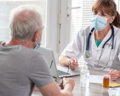 Elderly man consulting with a doctor 