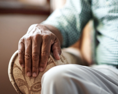 image of an elderly man sitting in a chair 